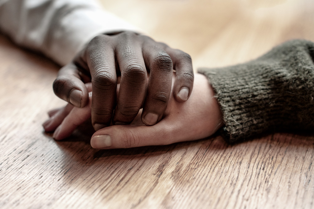 Hands holding each other giving support